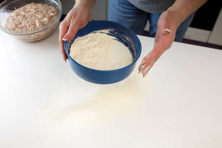 homemade dumplings in the kitchen without decorations. making dumplings with minced pork, beef and...