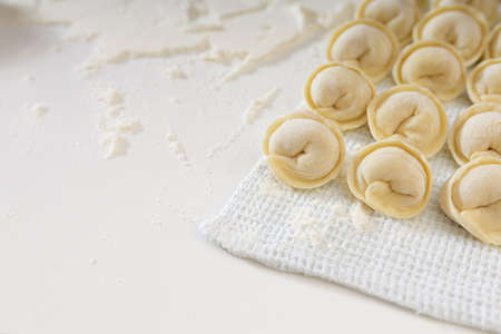 homemade dumplings in the kitchen without decorations. making dumplings with minced pork, beef and...
