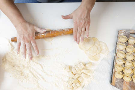 homemade dumplings in the kitchen without decorations. making dumplings with minced pork, beef and...