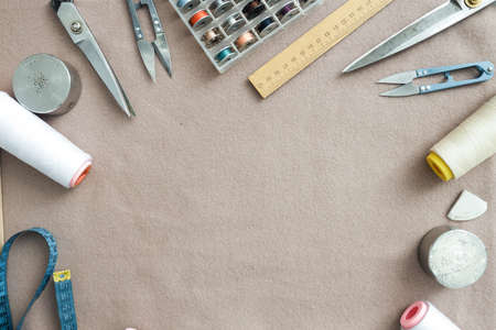 Tailor's tools on rag background with space for your text
