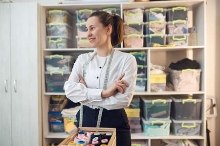 young girl seamstress while working on tailoring in her workshopの写真素材