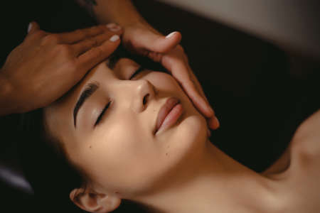 Beautiful girl has a facial massage in a beauty clinic.の写真素材