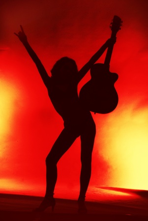 Woman with guitar silhouette on red background