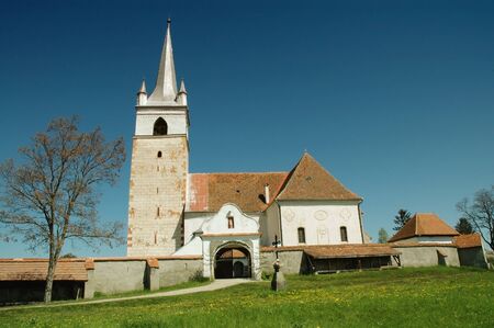 Church with painted tower in Transylvania, Romania の写真素材