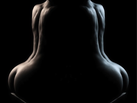 Sensual body of young woman over dark background  in mirrorの写真素材