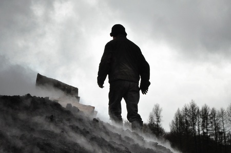 Charcoal pile burning in the outdoors, Romaniaの写真素材
