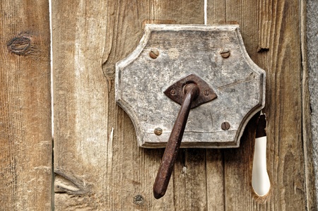 A very old door handle on a wooden doorの写真素材