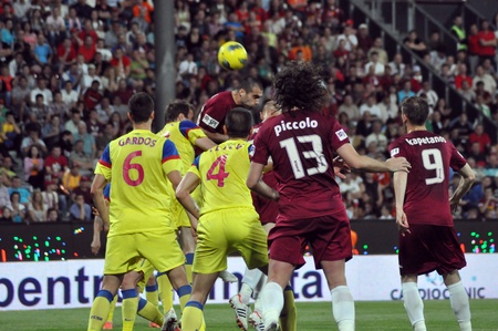 CLUJ-NAPOCA, ROMANIA MAY 20: Vasile Maftei (in red) hitting the ball at a Romanian National Championship soccer game CFR Cluj vs. Steaua Bucharest, May 20, 2012 in Cluj-Napoca, Romania のeditorial素材