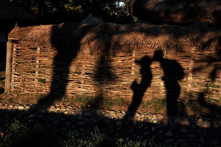 Hugging lovers shadow in late afternoon lights
