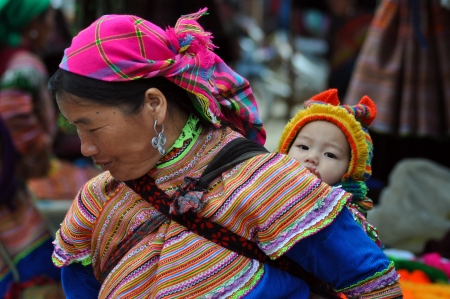 Bac Ha, Vietnam, February 23, 2013 - H'mong woman carrying her child in Bac Ha market, Vietnamのeditorial素材