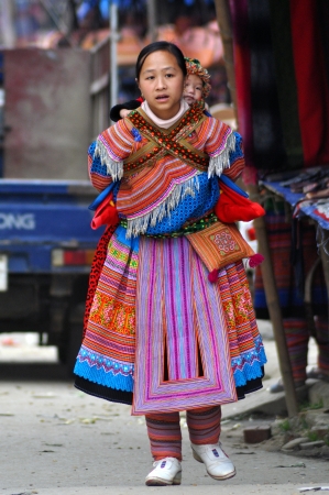 Bac Ha, Vietnam, February 23, 2013 - H'mong woman carrying her child in Bac Ha market, Vietnamのeditorial素材