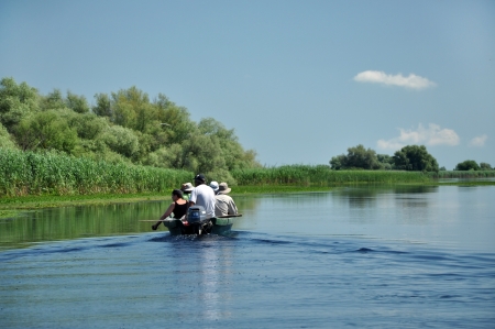 SULINA - JUNE 25: Unidentified people take boat trip with a local ranger in the Danube Delta Biosphere Reserve. Danube delta is the second largest river delta in Europe. On June 25 in Sulina, Romania  のeditorial素材