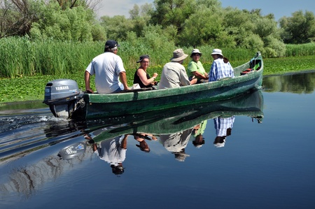 SULINA - JUNE 25: Unidentified people take boat trip with a local ranger in the Danube Delta Biosphere Reserve. Danube delta is the second largest river delta in Europe. On June 25 in Sulina, Romania  のeditorial素材