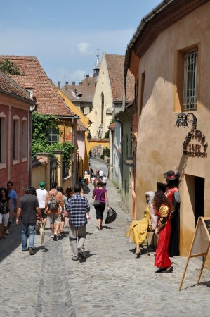 SIGHISOARA, ROMANIA  JUNE, 28: Tourists visiting Sighisoara (Schassburg, Segesvar), the only inhabited medieval citadel in Europe, part of UNESCO heritage. On June 28, 2013, in Sighisoara, Romaniaのeditorial素材