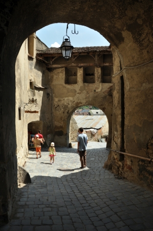 SIGHISOARA, ROMANIA  JUNE, 28: Tourists visiting Sighisoara (Schassburg, Segesvar), the only inhabited medieval citadel in Europe, part of UNESCO heritage. On June 28, 2013, in Sighisoara, Romaniaのeditorial素材