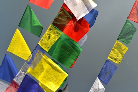 Buddhist Tibetan prayer flags blowing in the windの写真素材