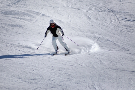 KAPRUN - MARCH 5  Unidentified skier skiing down the slope in a beautiful sunny day, in the Austrian Alps, during the school vacation  On March 5, 2013, in Kitzsteinhorn, Austria のeditorial素材