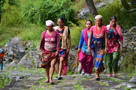 GHANDRUK, NEPAL - OCTOBER 6  A group of Gurung women going to work in the mountains  Gurungs are the biggest ethnic group in the Himalayas  On October 6, 2013 in Ghandruk, Nepal のeditorial素材