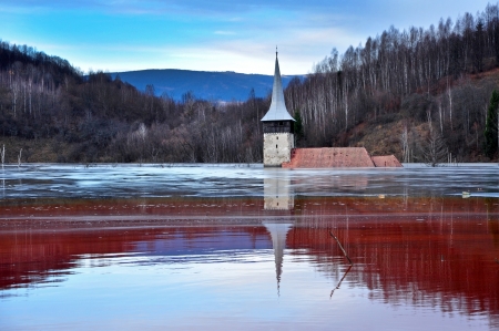 A flooded church in a toxic red lake  Water polluting by a copper mineの写真素材