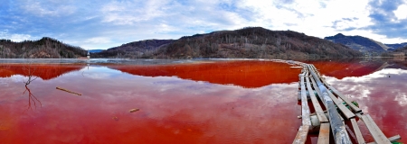 Environmental disaster  Panorama of a lake full with contaminated water from a mine in Geamana, Rosia Montana, Romania のeditorial素材