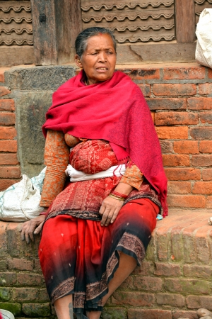 BHAKTAPUR, NEPAL - OCT 10  Woman from Bhaktapur enjoying the holidays during the holy Hindu Dashain festival in the Durbar square  On October 10, 2013 in Kathmandu, Nepal のeditorial素材