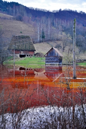 An abandoned house flooded by polluted water from a copper open cast mine の写真素材
