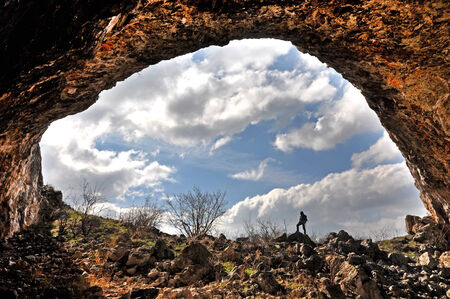 A rock arch and a cave entranceの写真素材