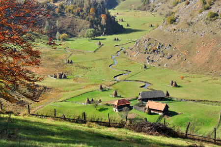 Autumn landscape with a small village in the mountainsの写真素材