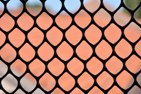 Metallic window fence, grid. Shallow depth of fieldの写真素材