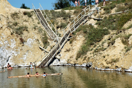 OCNA SIBIULUI, ROMANIA - JULY 9: Unidentified people swimming and floating on the water of the abandoned salt mine. On July 9, 2005 in Ocna Sibiului (Vizakna, Salzburg), Romaniaのeditorial素材