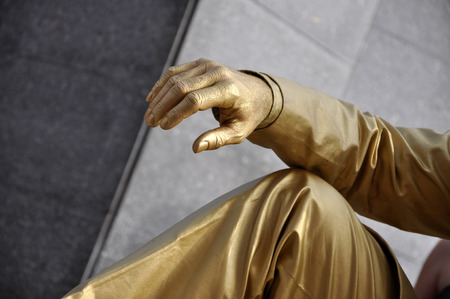 CLUJ NAPOCA  MAY 24: Living statue performer in golden costume doing a busking mime inside the Man.In.Fest during the Cluj Days of Cluj. On May 24 2015 in in Cluj Romaniaのeditorial素材