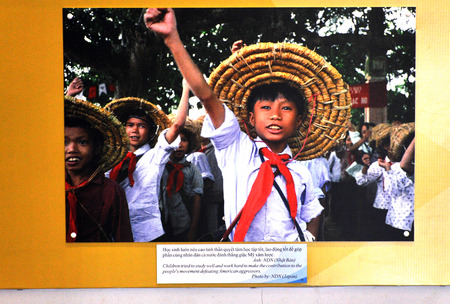 HO CHI MINH  MARCH 7: Propaganda photo of Vietnamese children celebrating the 40th Anniversary of the Communist Party in the War Remnants Museum. On March 7 2013 in Saigon Vietnamのeditorial素材