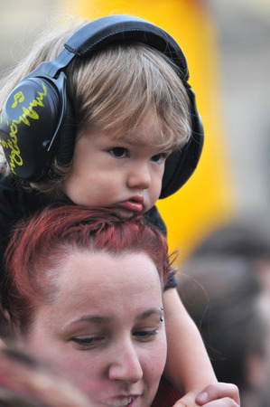 BONTIDA - JUNE 26, 2015: A child wearing ear muff for kids during a concert at Electric Castle Festival at June 26, 2015 in the Banffy castle in Bontida, Romaniaのeditorial素材