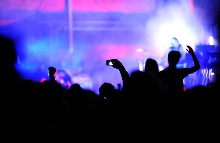BONTIDA, ROMANIA - JUNE 28, 2015: Crowd of partying people taking photos with smartphone at Electric...