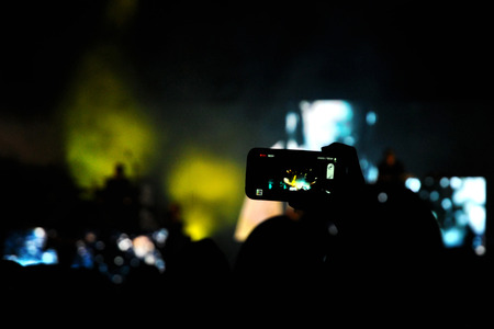 BONTIDA, ROMANIA - JUNE 28, 2015: Crowd of partying people taking photos with smartphone at Electric Castle Festivalのeditorial素材