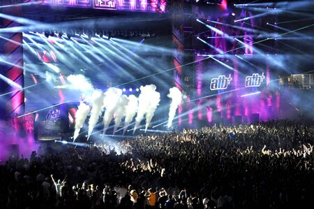 CLUJ NAPOCA, ROMANIA  JULY 30, 2015: Crowd of party people raising their hands during an ATB live...