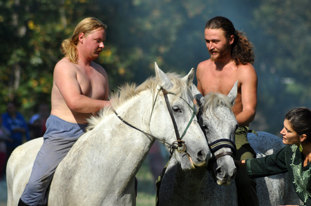 CLUJ-NAPOCA, ROMANIA - OCTOBER 3: Members of Eagles of Calata Nomadic group performing a free equestrian demonstration with Hunnic and archaic Hungarian costumes. On October 3, 2015 in Cluj, Romaniaのeditorial素材
