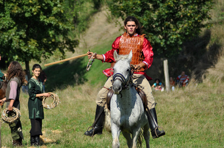 CLUJ-NAPOCA, ROMANIA - OCTOBER 3: Members of Eagles of Calata Nomadic group performing a free equestrian demonstration with Hunnic and archaic Hungarian costumes. On October 3, 2015 in Cluj, Romaniaのeditorial素材
