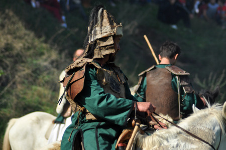 CLUJ-NAPOCA, ROMANIA - OCTOBER 3: Members of Eagles of Calata Nomadic group performing a free equestrian demonstration with Hunnic and archaic Hungarian costumes. On October 3, 2015 in Cluj, Romaniaのeditorial素材