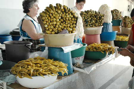 YEREVAN, ARMENIA - JULY 16, 2006: Unidentified sales persons selling pickled cucumbers and peppers in the bazaar of Yerevan market, Armeniaのeditorial素材