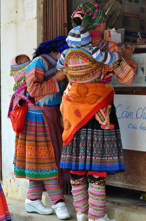 SAPA, VIETNAM - FEBRUARY 22, 2013: Hmong women at Bac Ha market in Northern Vietnam. Bac Ha is hilltribe market where people come to trade for goods in traditional costumesのeditorial素材