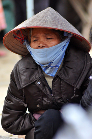 SAPA, VIETNAM - FEBRUARY 22, 2013: Hmong women at Bac Ha market in Northern Vietnam. Bac Ha is hilltribe market where people come to trade for goods in traditional costumesのeditorial素材