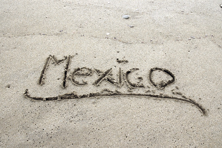 Mexico written in sand on the beachの写真素材