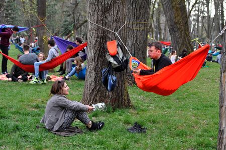 CLUJ-NAPOCA, ROMANIA - APRIL 1, 2016: Young people relaxing in hammocks in the Central park during the Big Hammock Dayのeditorial素材