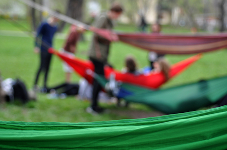 CLUJ-NAPOCA, ROMANIA - APRIL 1, 2016: Young people relaxing in hammocks in the Central park during the Big Hammock Dayのeditorial素材