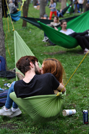 CLUJ-NAPOCA, ROMANIA - APRIL 1, 2016: Young people relaxing in hammocks in the Central park during the Big Hammock Dayのeditorial素材