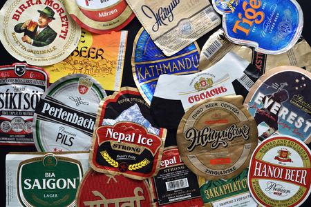 CLUJ-NAPOCA, ROMANIA - APRIL 29, 2016: Background of beer bottle labels, a mix of various European and Asian brandsのeditorial素材