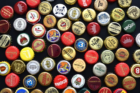 CLUJ-NAPOCA, ROMANIA - APRIL 29, 2016: Background of beer bottle caps, a mix of various European and Asian brandsのeditorial素材
