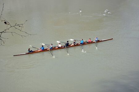 ROME, ITALY - MARCH 14, 2016: Team canoeing on the river Tiber in the city of Rome, Italy