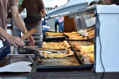 CLUJ NAPOCA, ROMANIA - JULY 8, 2016: Cook prepares a different types of pastry filled with cheese at the Street Food Festival of Clujのeditorial素材